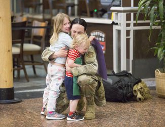 Katherine Witt reunites with her children after seven months in Afghanistan. Photo courtesy of the author.
