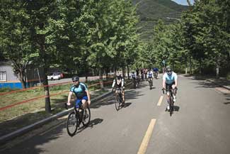 Participants of the 2021 Cycling Challenge take part in a group ride in Gachang Valley, South Korea. Studies have shown that exposure to nature and outdoor activities can be beneficial to veterans who suffer from post-traumatic stress, traumatic brain injury, depression, or other conditions, Photo by Melissa Diehl, courtesy of the U.S. Army. 