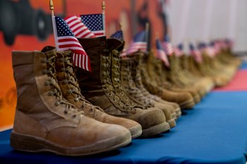 U.S. Airmen from the 332nd Air Expeditionary Wing honor the daily estimated number of veterans who take their own lives, symbolized by 22 pairs of boots in recognition of Suicide Prevention Month. Sept. 8, 2021.