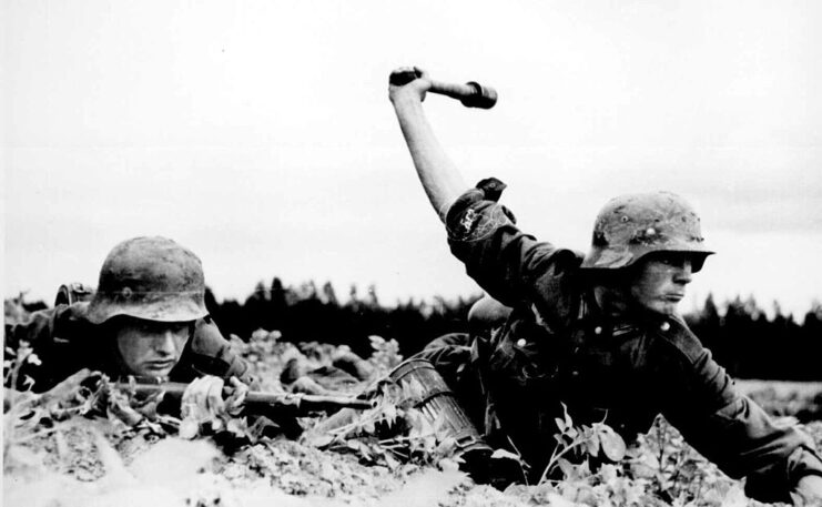 Two soldiers lying on their stomachs on the ground
