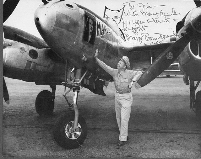 Richard Bong standing with the Lockheed P-38 Lightning 'Marge'