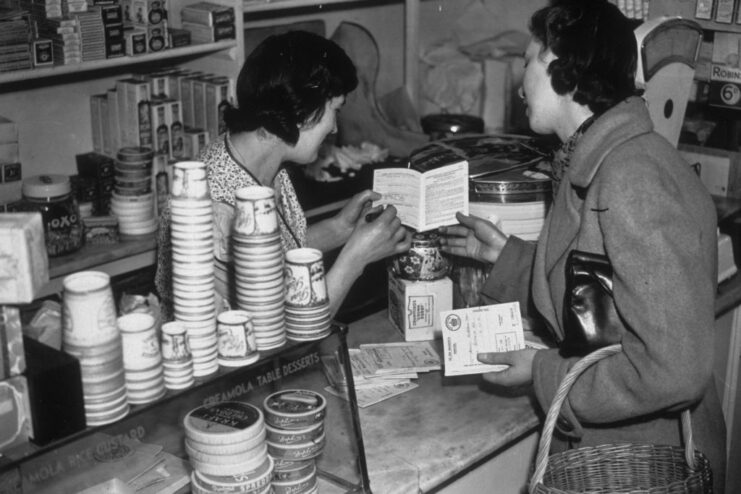 Woman showing a grocer her rations book