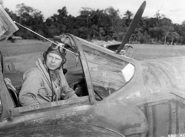 Richard Bong sitting in the cockpit of an aircraft