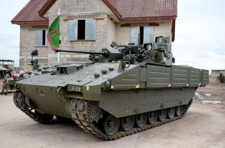 Ajax armored fighting vehicle (AFV) parked outside of a building