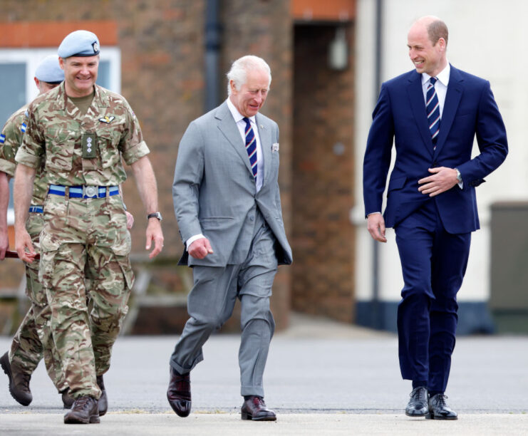 King Charles III and William, Prince of Wales walking with two members of the Army Air Corps
