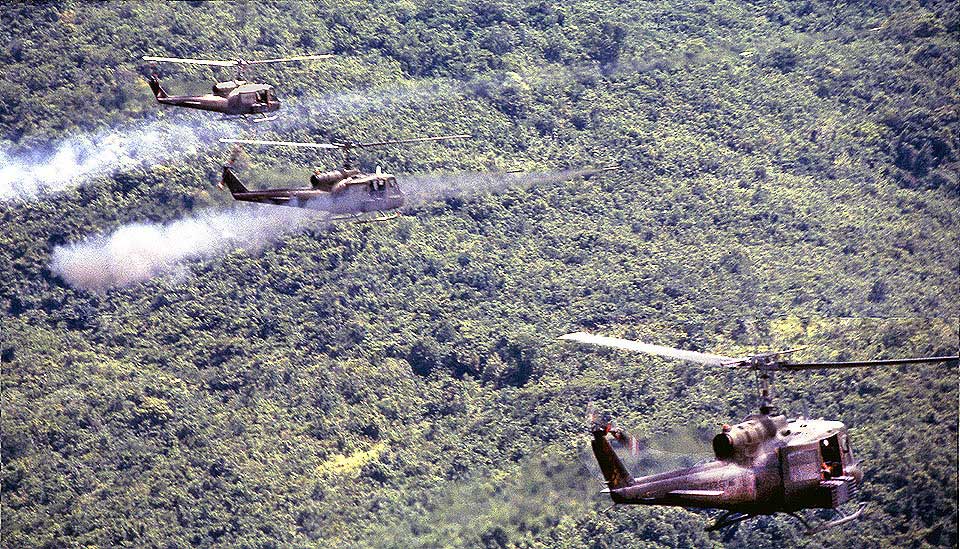 A battery of aerial rocket artillery bombards NVA emplaced above Bong Son in the Central Highlands. Photo by Marvin J. Wolf.