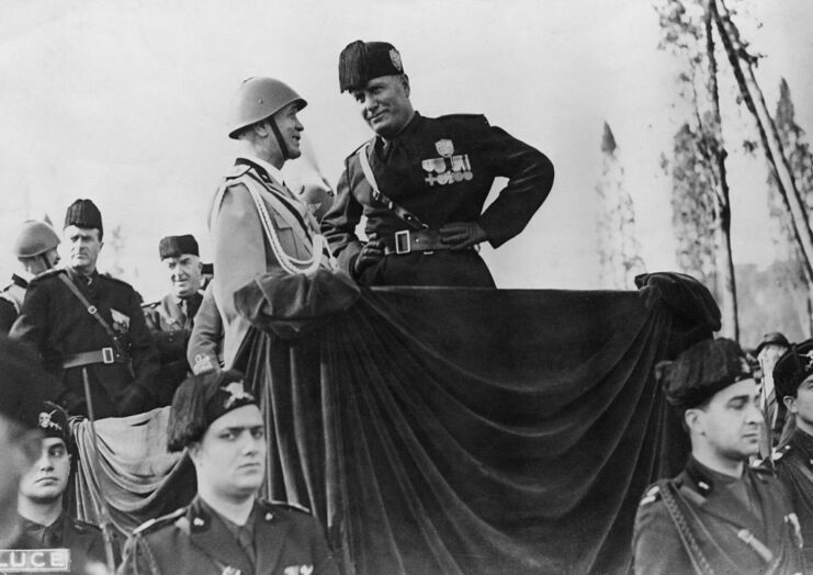 Military personnel speaking with Benito Mussolini